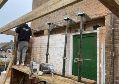 A builder creating space for a RSJ, using Acrow props