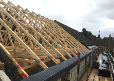 Roof trusses being installed on double storey extension