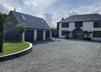 Triple garage and driveway and completed front elevation