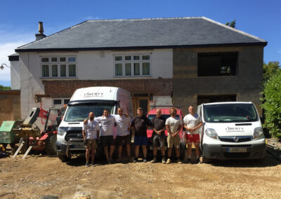 The Liberty build team in front of the partially completed extension