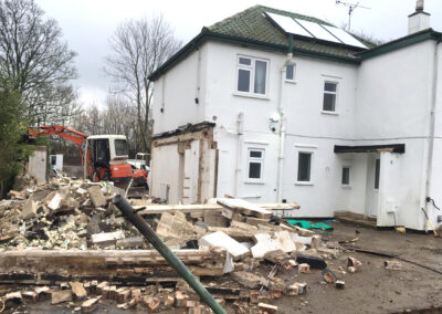 Contractor beginning demolition of an older extension, before the new wraparound extension is built